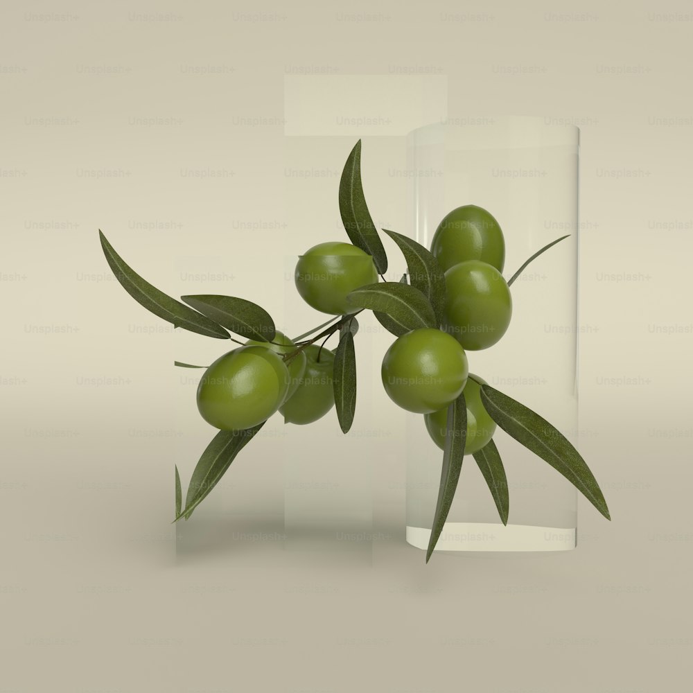 a glass vase filled with green olives on top of a table