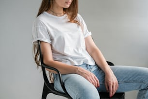 a woman sitting on a chair with her legs crossed
