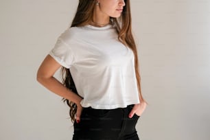 a woman wearing a white shirt and black pants