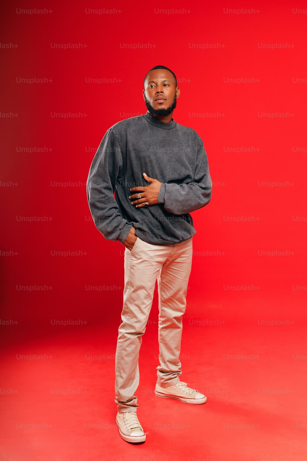 a man standing in front of a red background