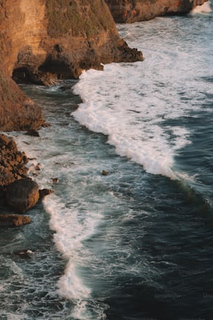 a body of water near a rocky cliff
