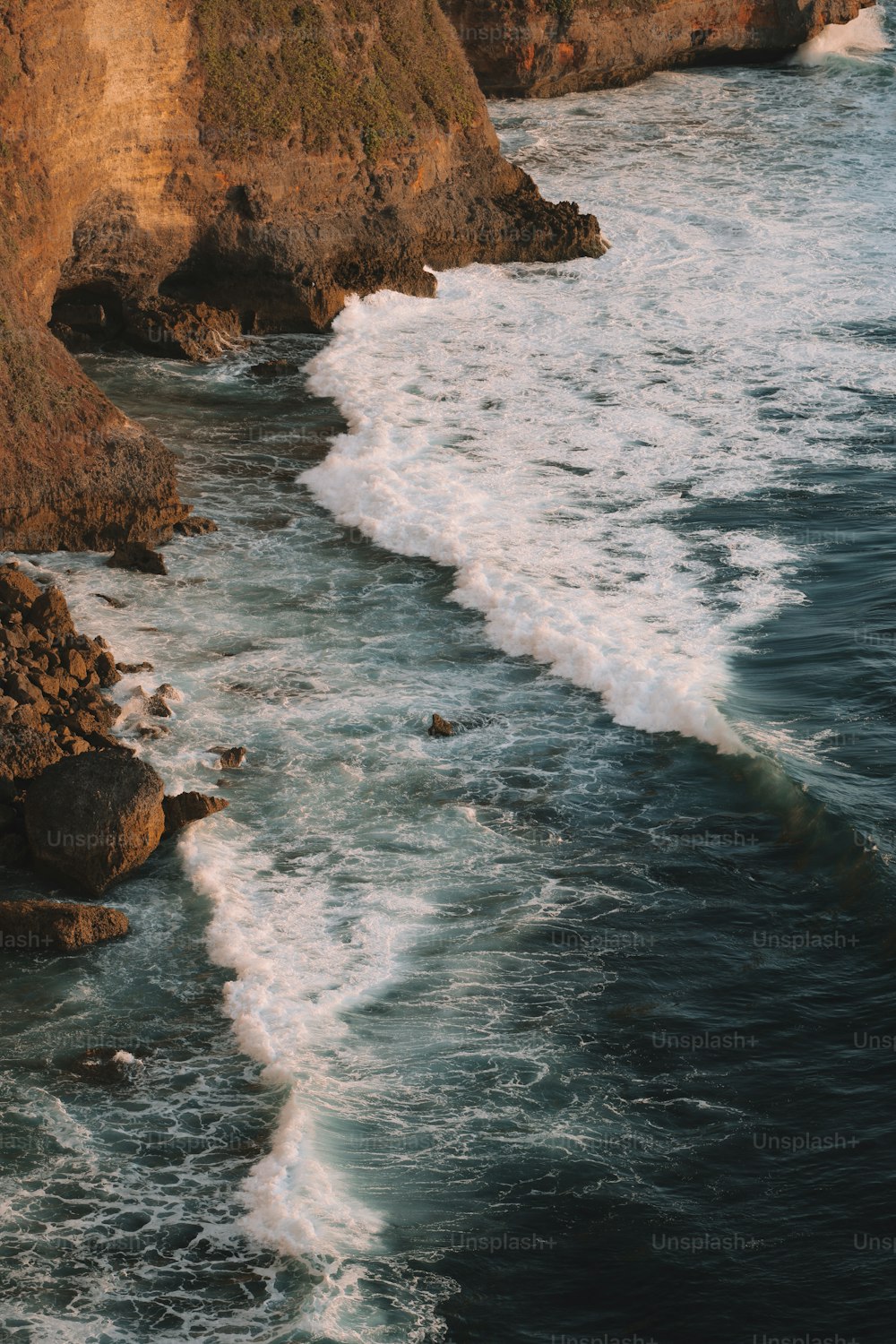 a body of water near a rocky cliff