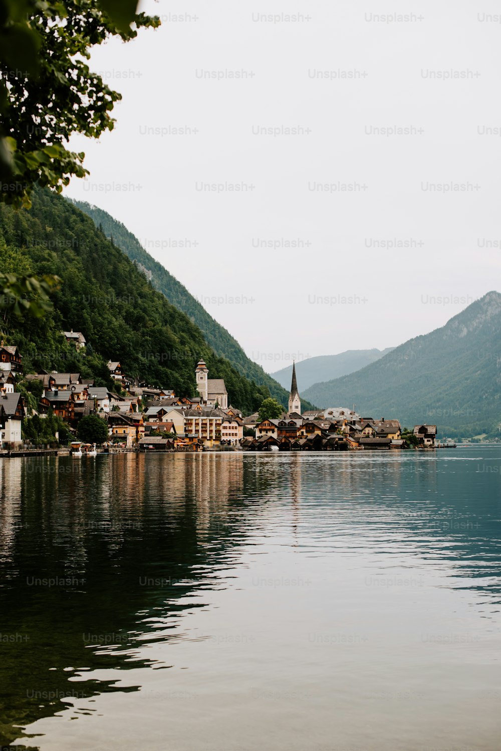 a small village on a lake surrounded by mountains