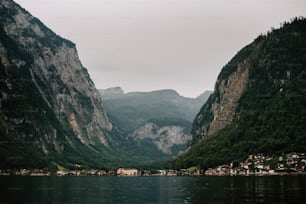 a body of water surrounded by mountains and houses