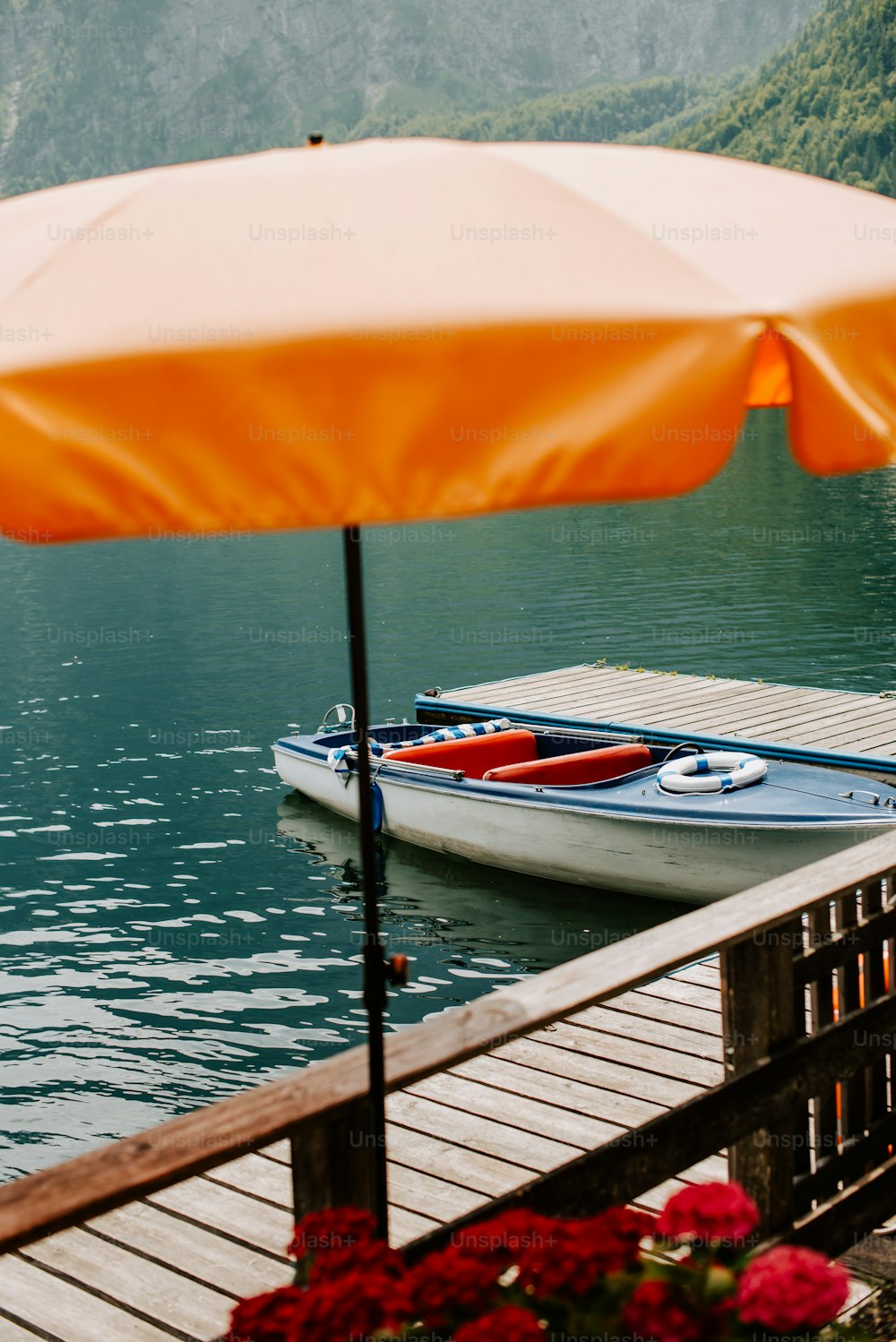 a boat sitting on a lake next to a pier