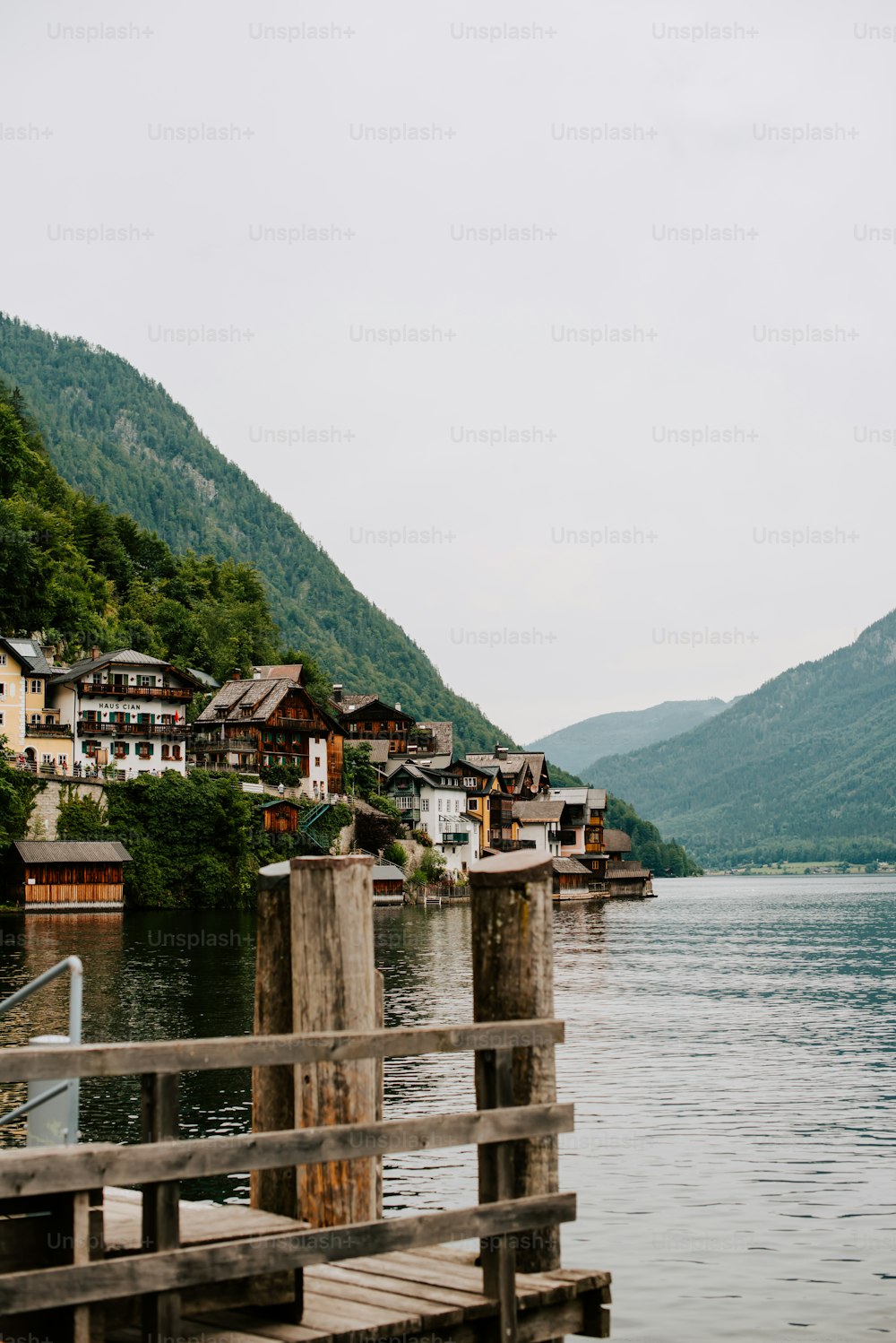 a body of water surrounded by mountains and houses