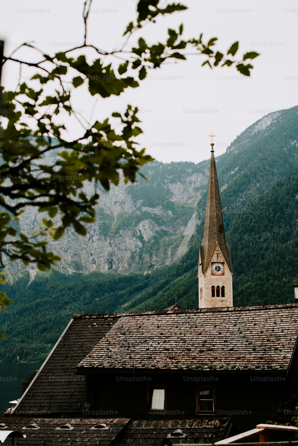 a church with a steeple surrounded by mountains