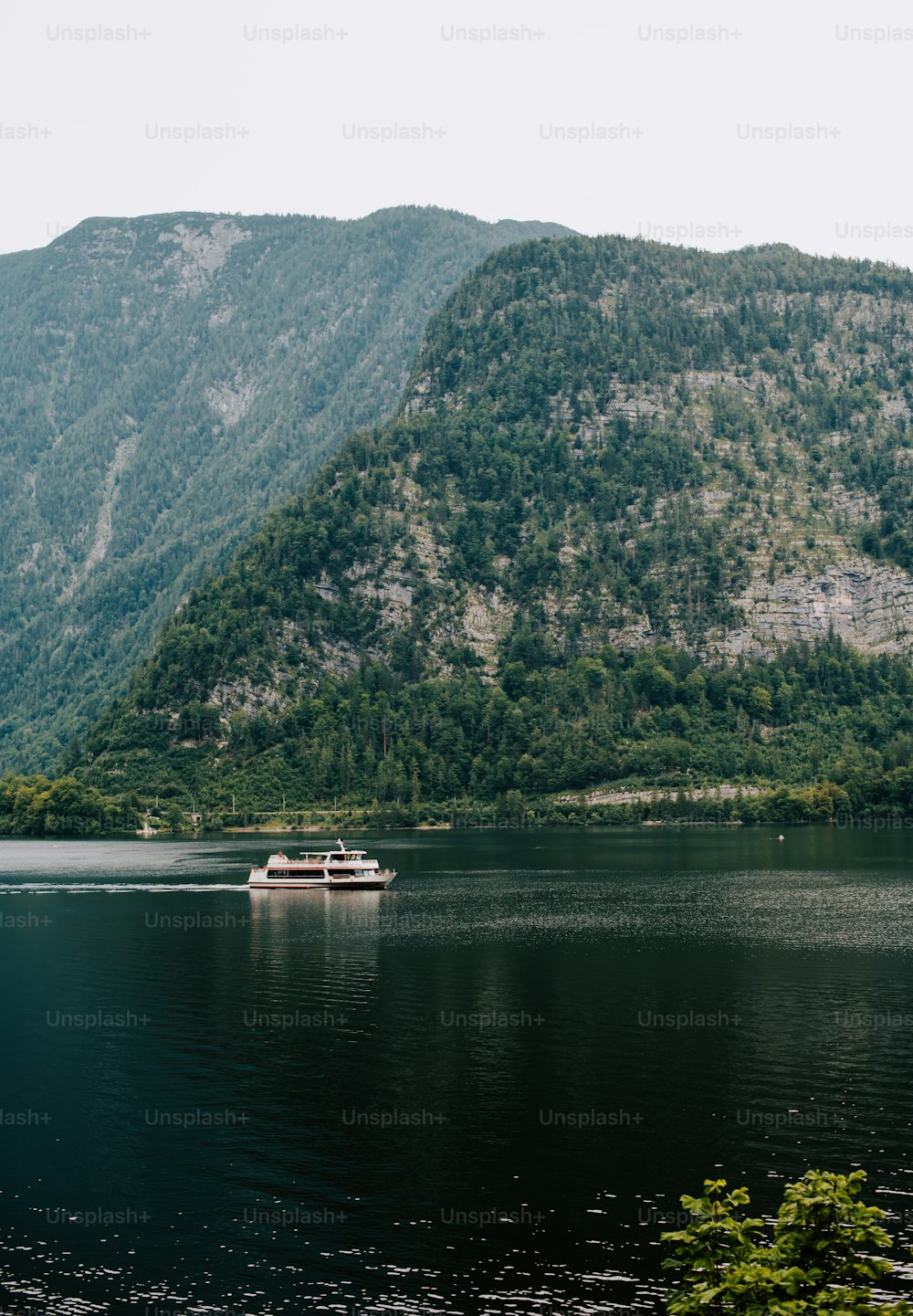a boat on a lake in front of a mountain