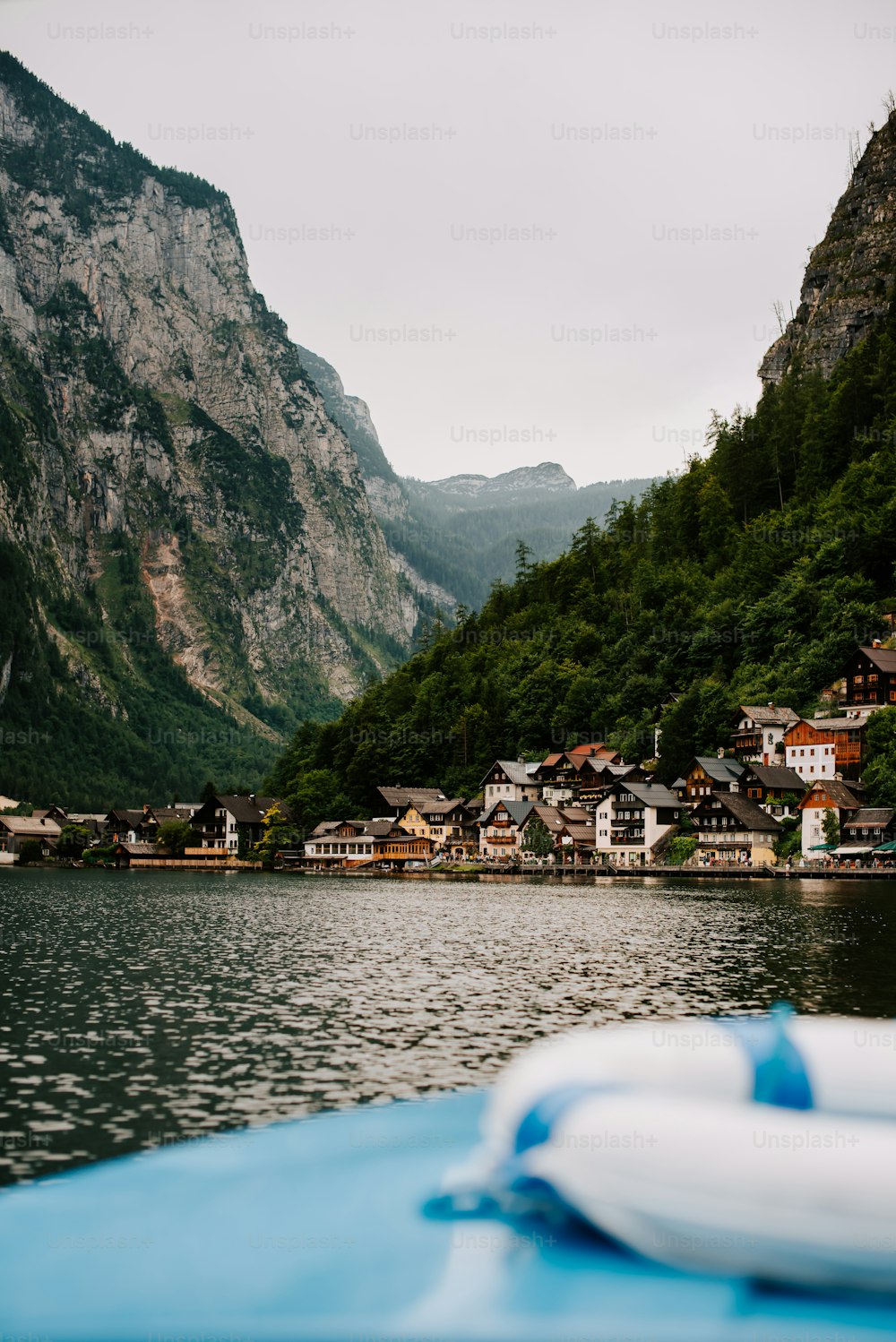 a body of water surrounded by mountains and houses