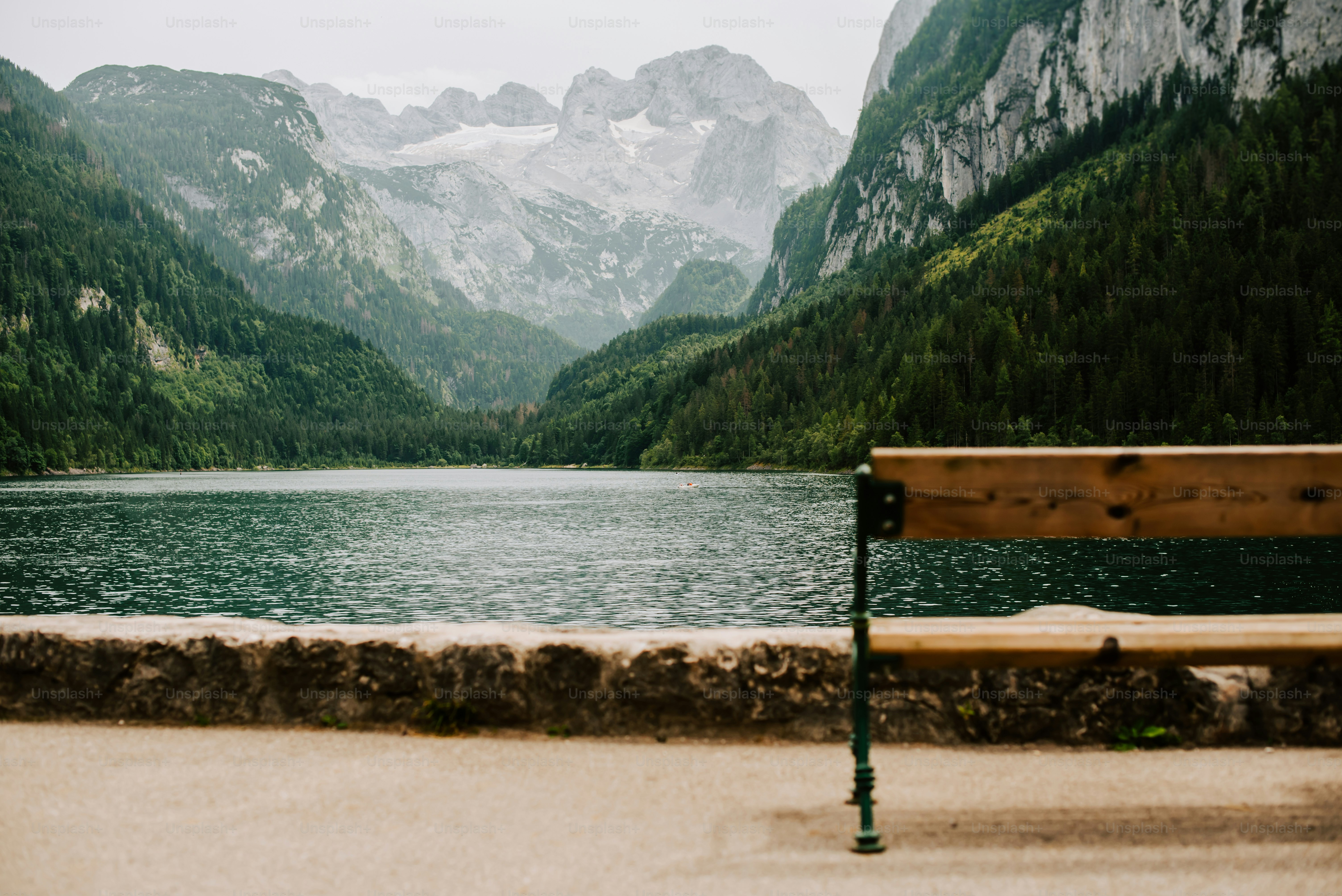 a wooden bench sitting next to a body of water