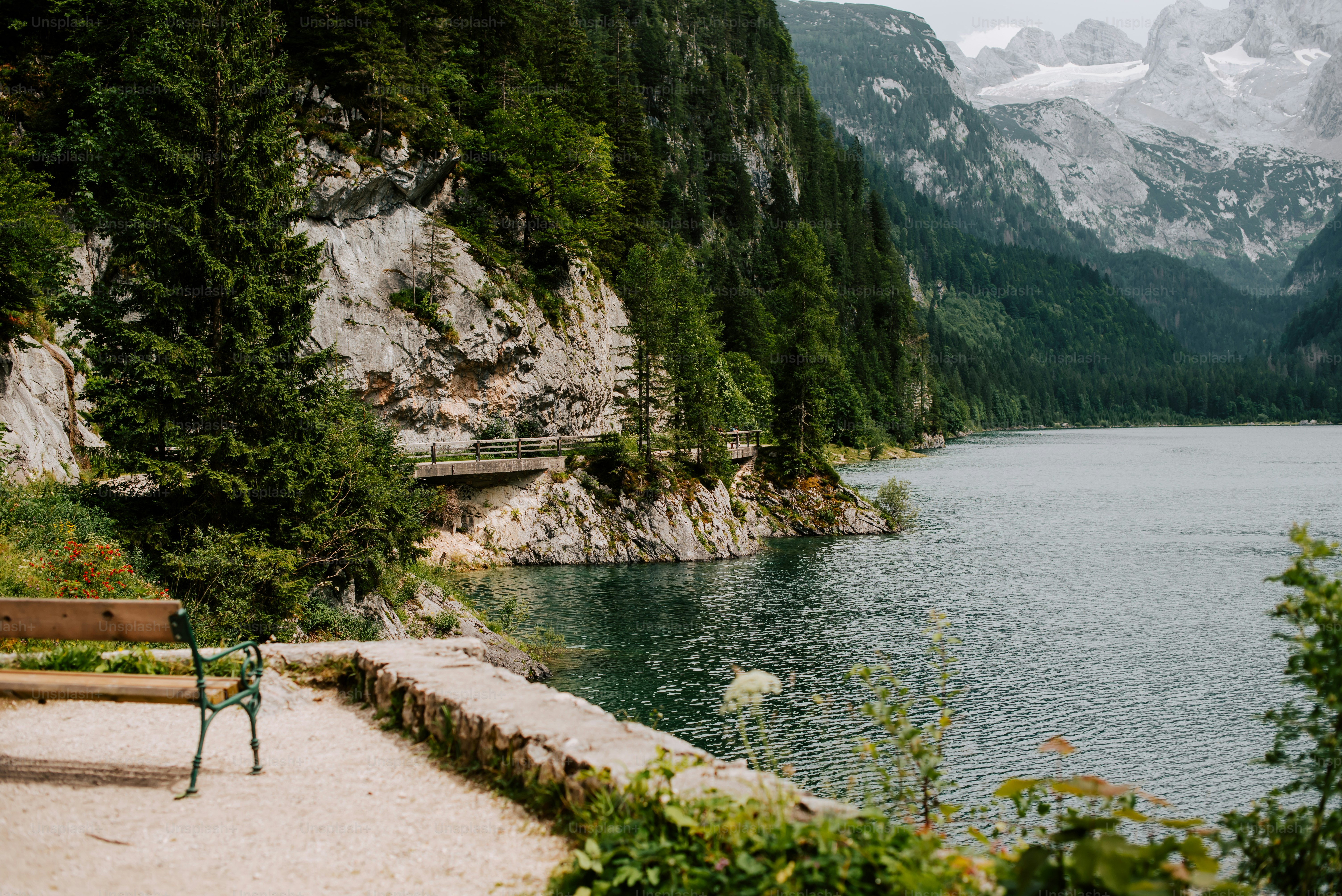 a bench sitting on the shore of a lake