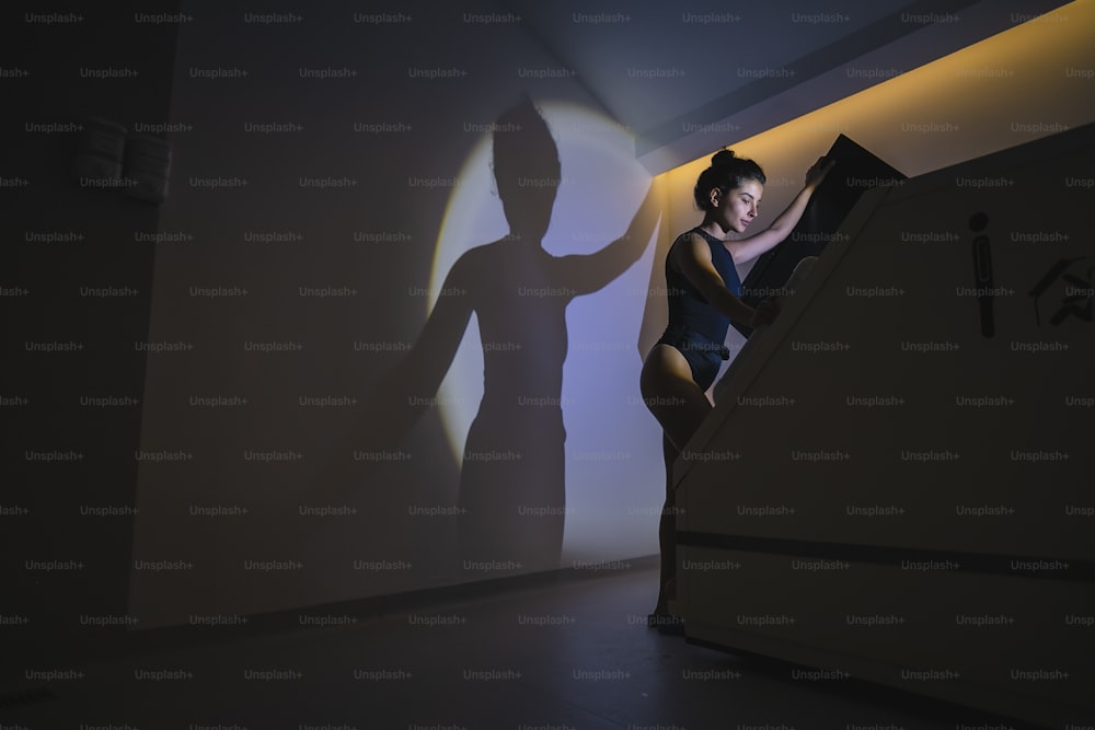 a man sitting on a stair case next to a shadow of a person
