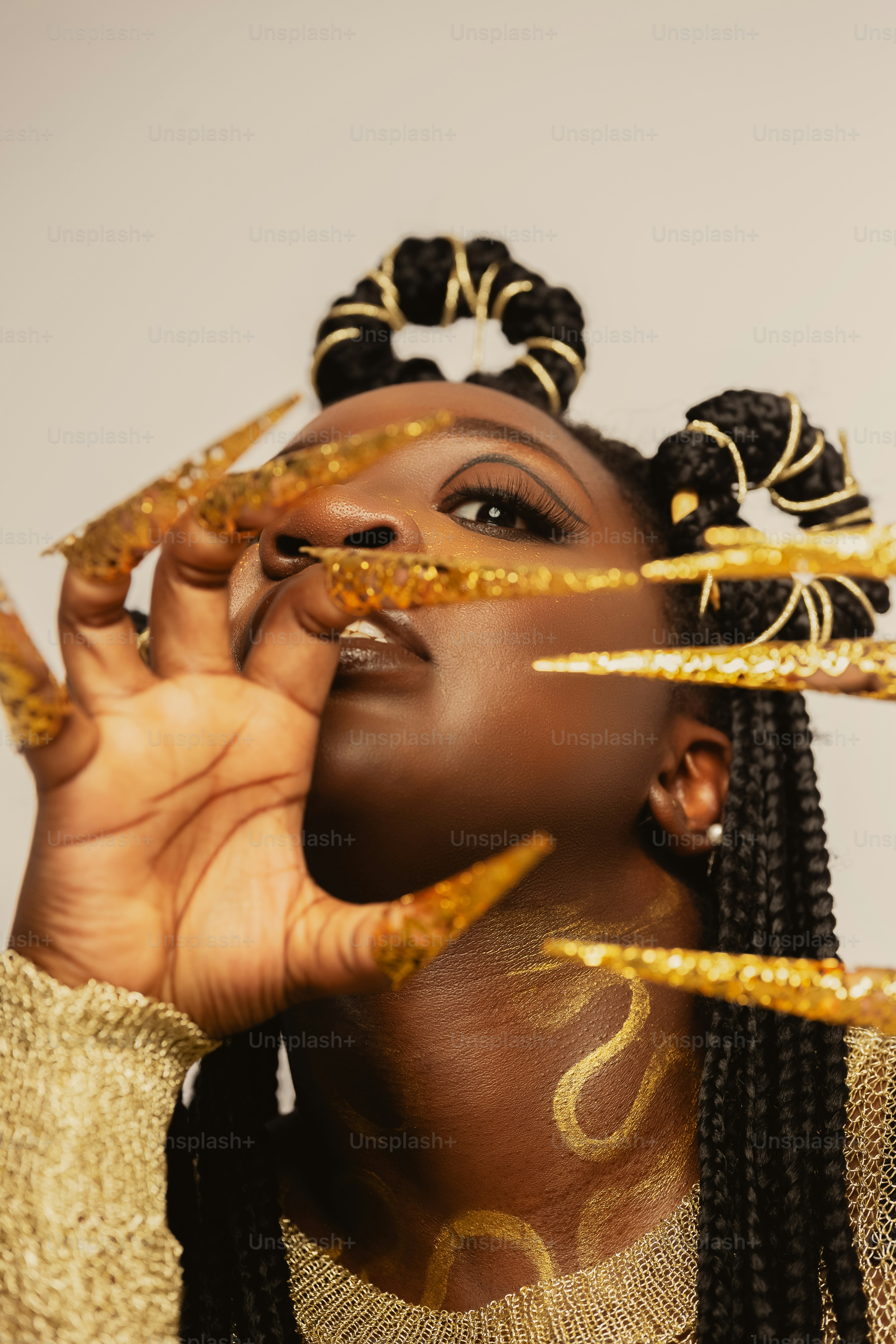 A woman with gold paint on her face and hands photo – Wallpaper Image ...