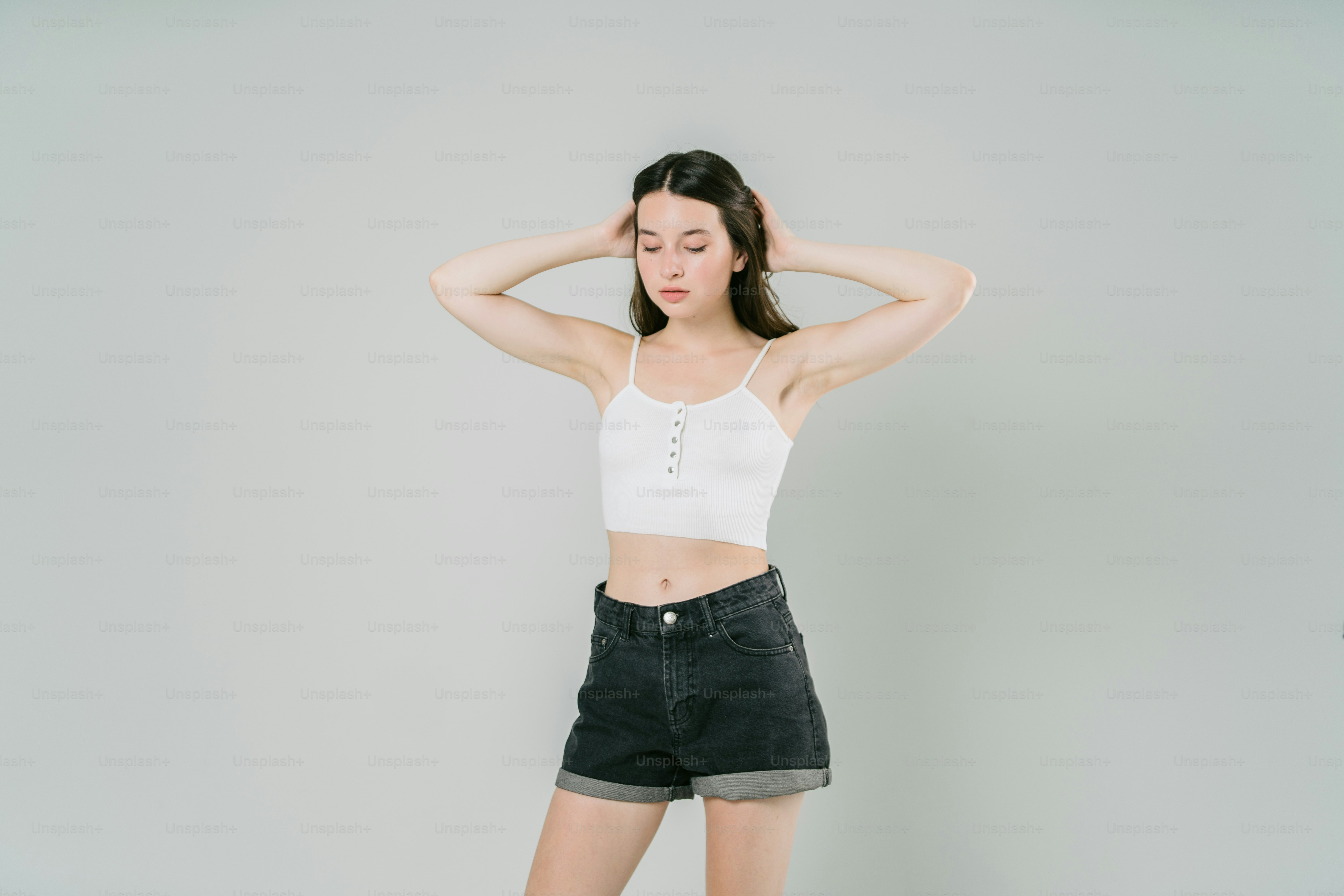 a woman with her hands on her head