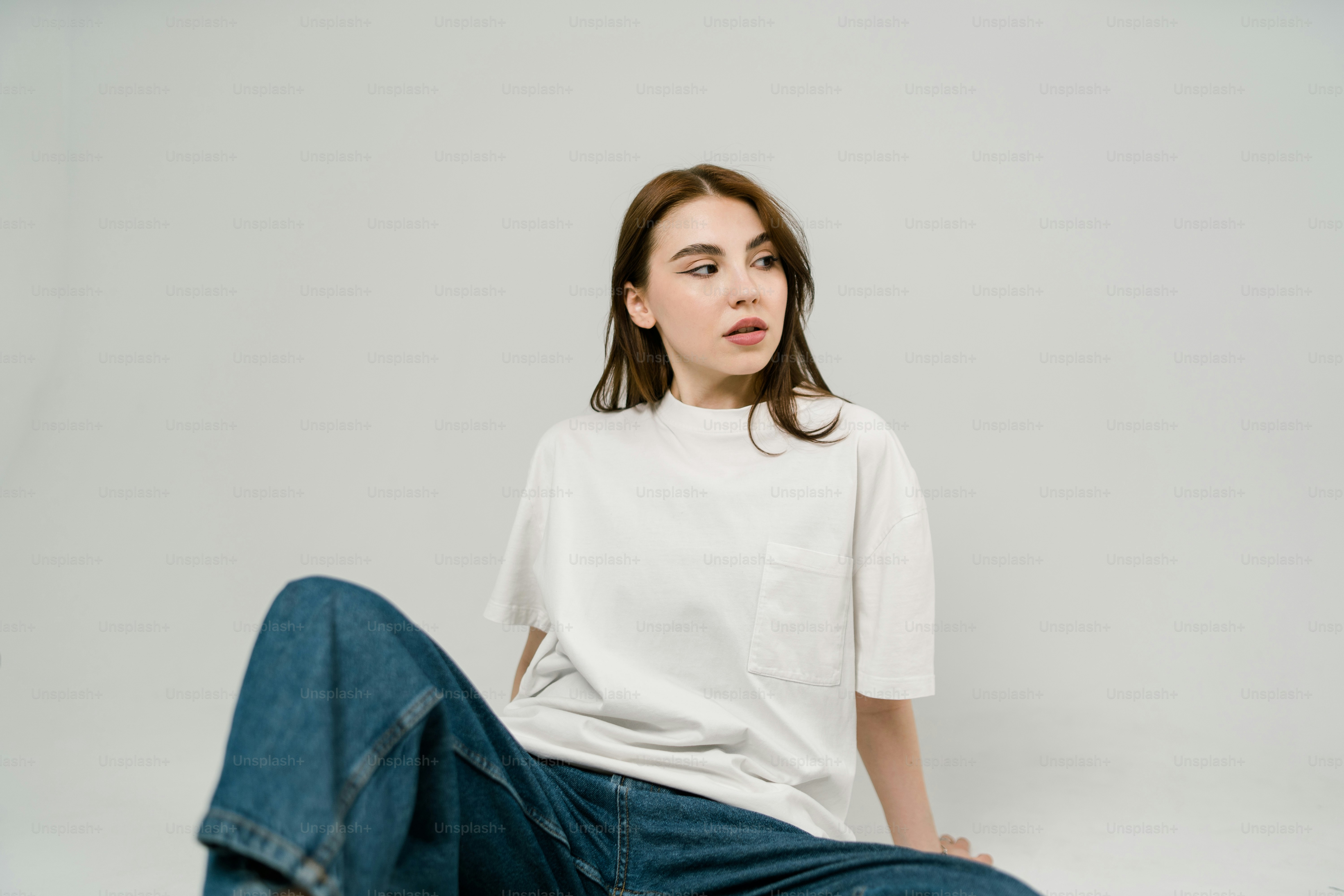 a woman sitting on the ground with her legs crossed
