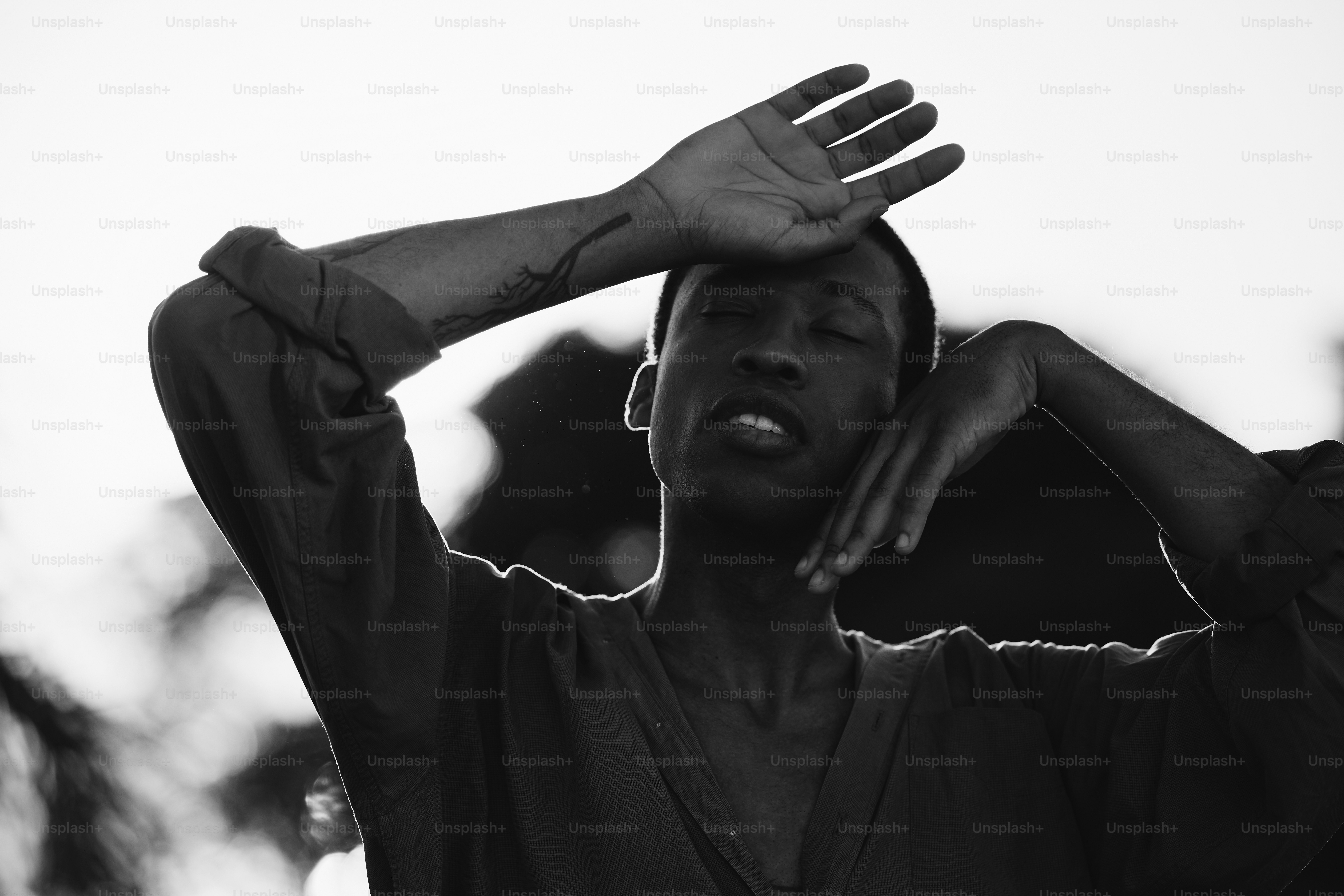 a man holding his hands up to his head