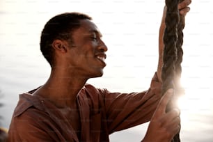 a man holding onto a rope in the air