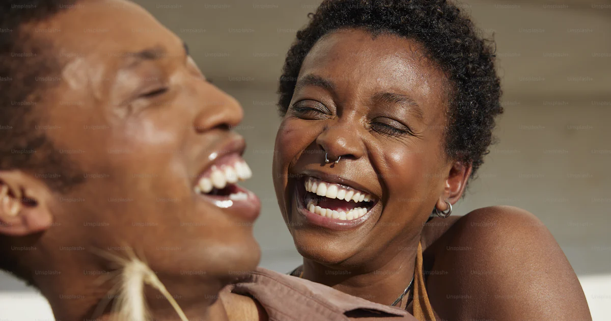 A man and a woman are laughing together photo – Having fun Image on ...