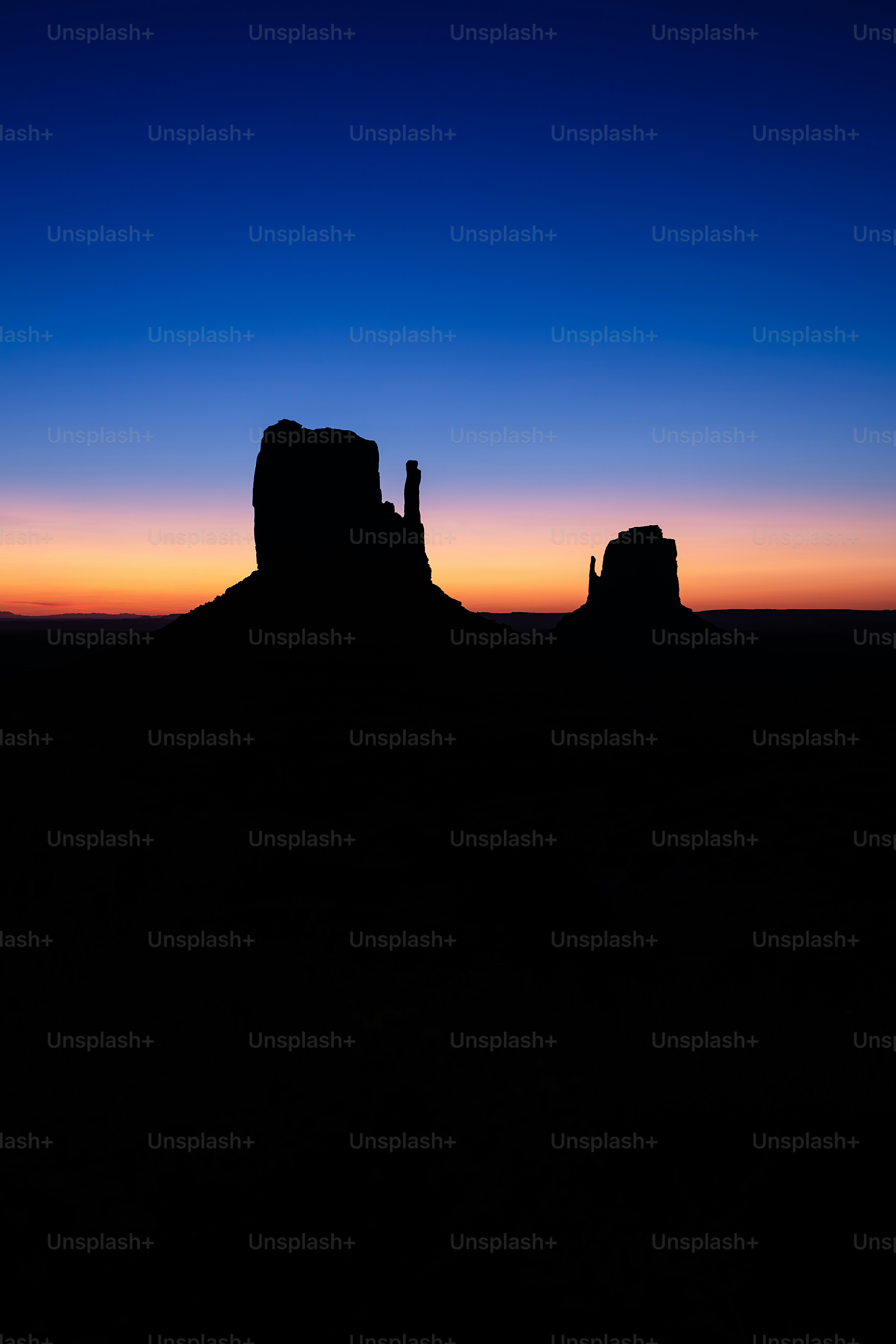 a silhouette of a rock formation at sunset