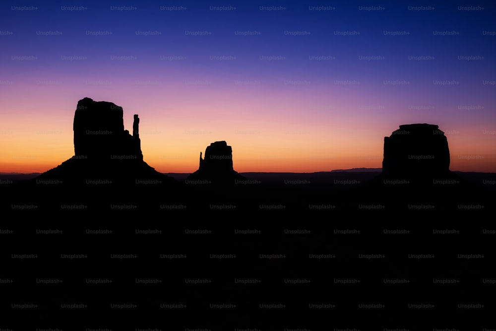 前景にいくつかの岩がある砂漠の夕日の景色