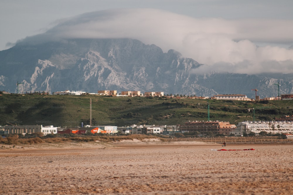 a beach with a mountain in the background