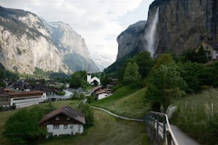 a scenic view of a village in the mountains