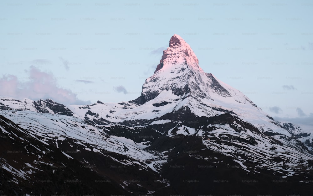 a snow covered mountain with a sky background