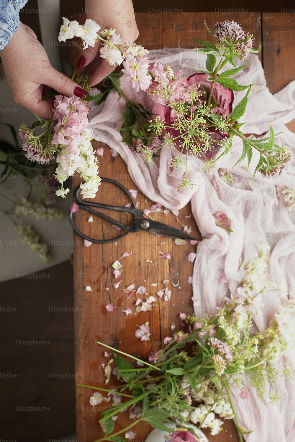 une personne coupant des fleurs avec une paire de ciseaux