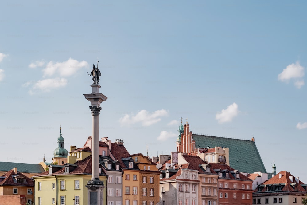 a row of buildings with a statue on top of one of them