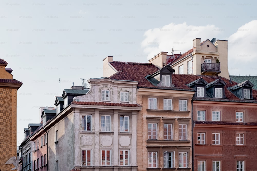 a row of buildings with a clock tower in the background