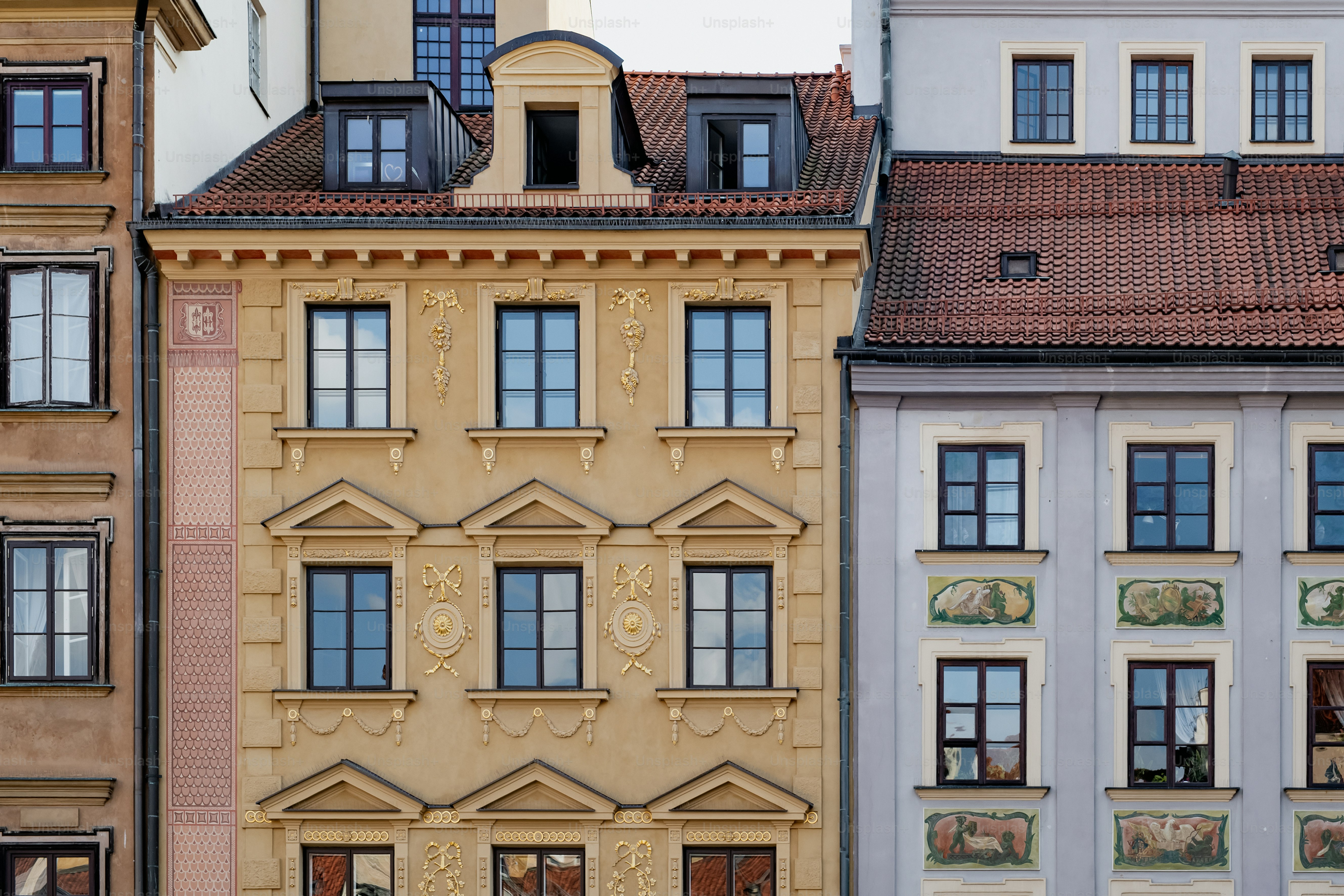a row of buildings with a clock on each of them