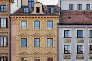 a row of buildings with a clock on each of them