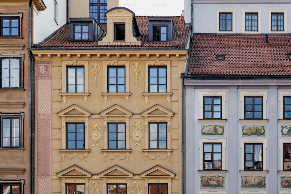 a row of buildings with a clock on each of them