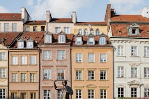 a row of buildings with a statue in front of them