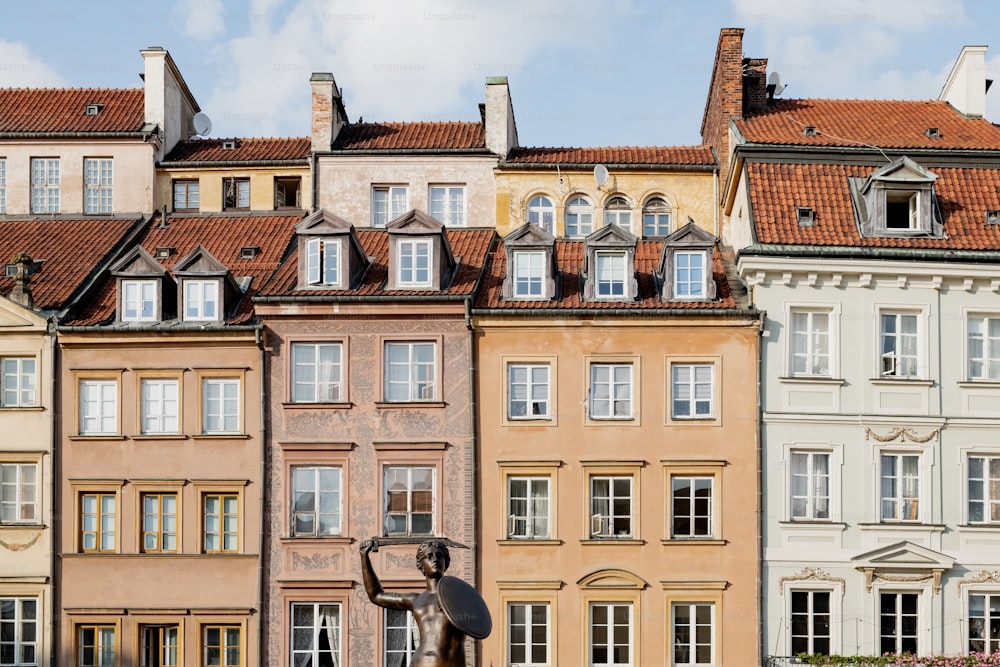 a row of buildings with a statue in front of them