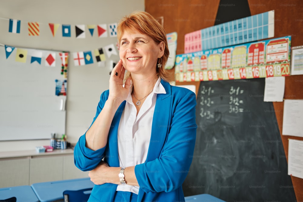 a woman standing in front of a chalk board