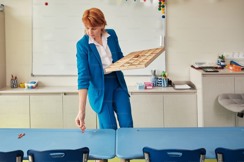 a woman in a blue suit holding a wooden board