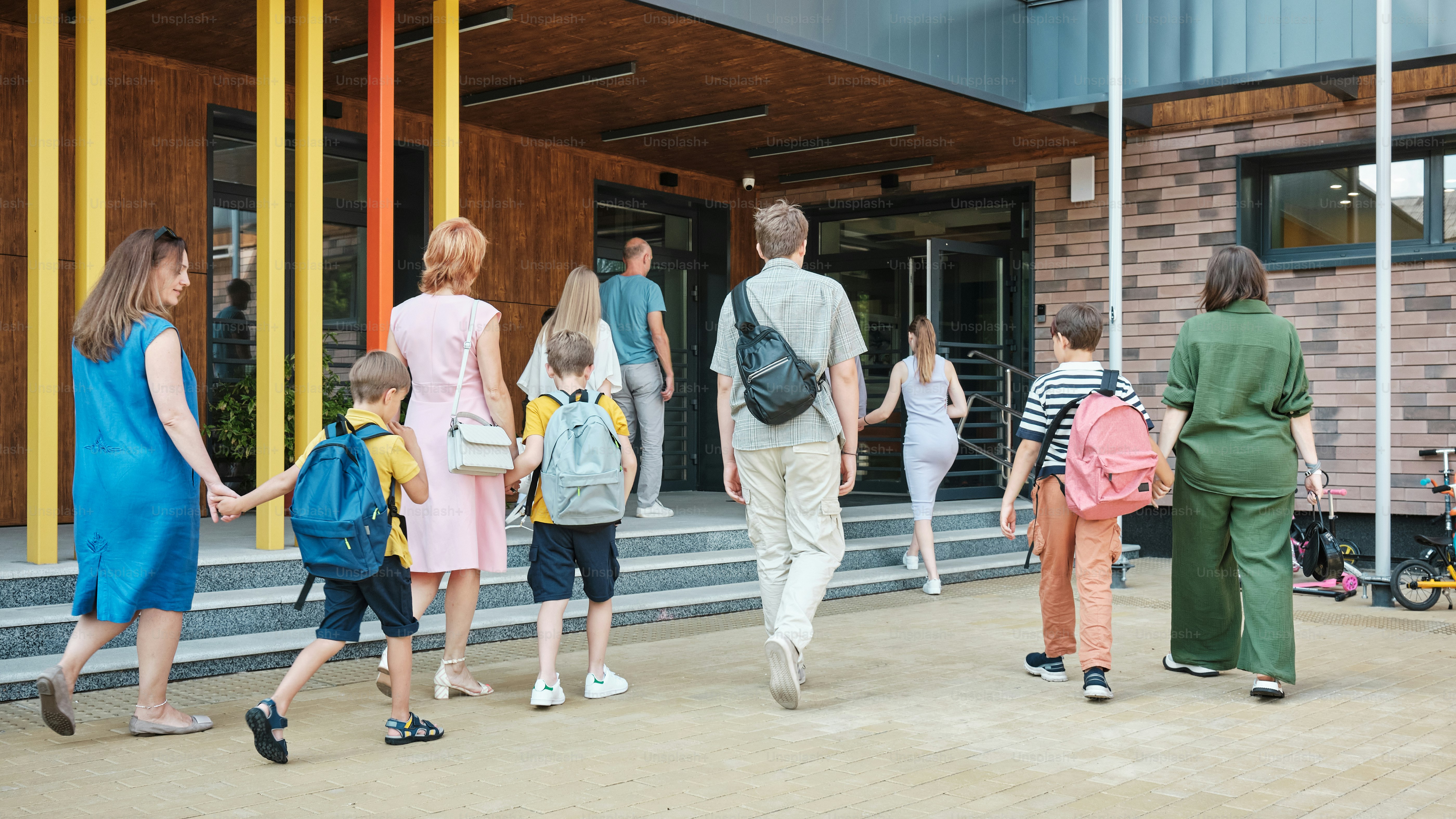 a group of people walking down a sidewalk