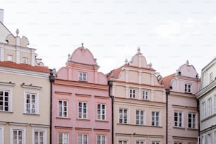 a row of buildings with a clock on each of them