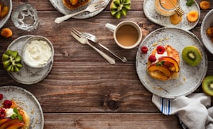 a table topped with plates of food and a cup of coffee