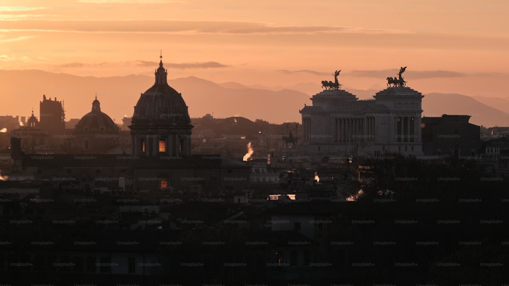 the sun is setting over the city of rome