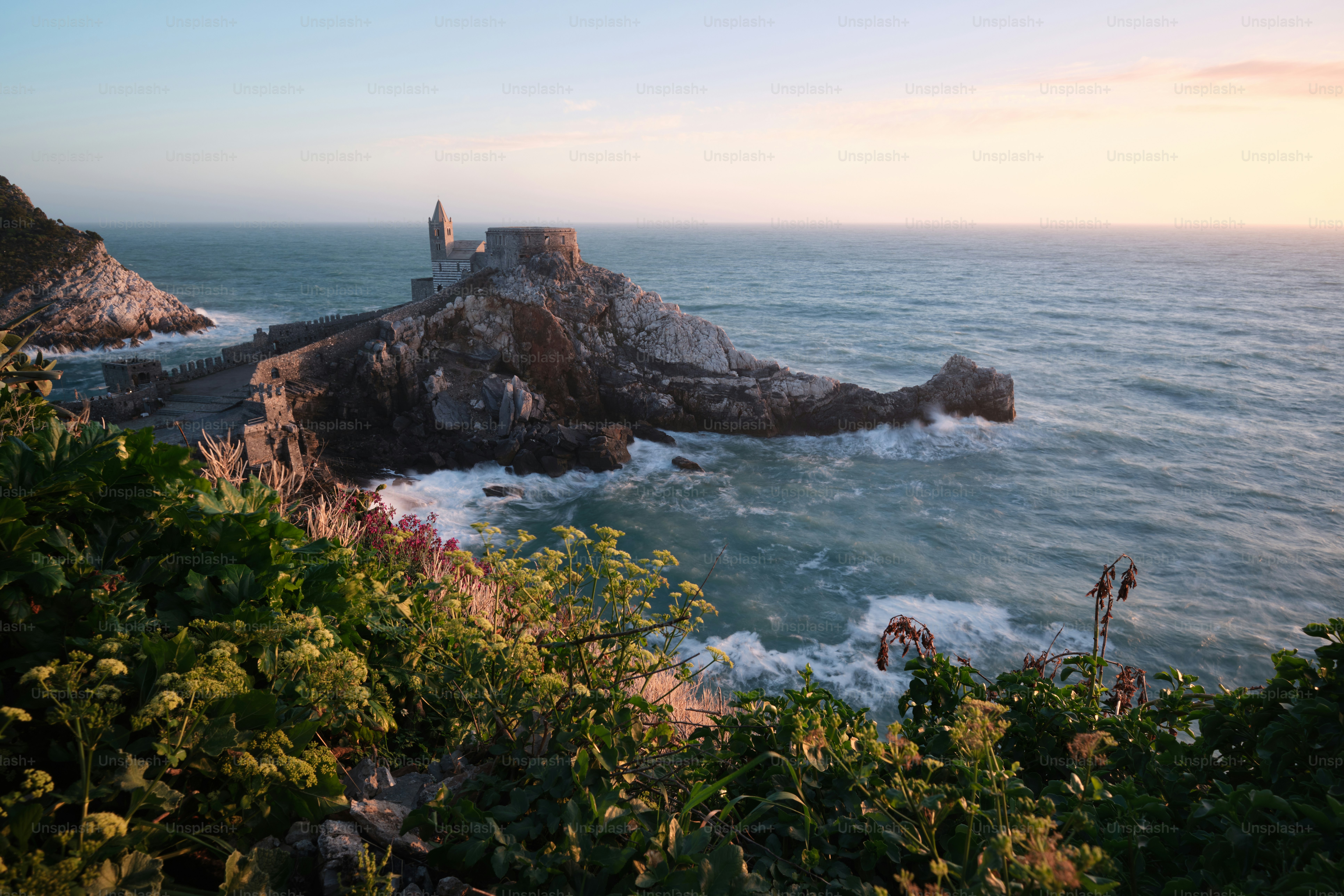 a large body of water next to a rocky cliff