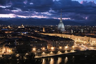 a view of a city at night with clouds in the sky