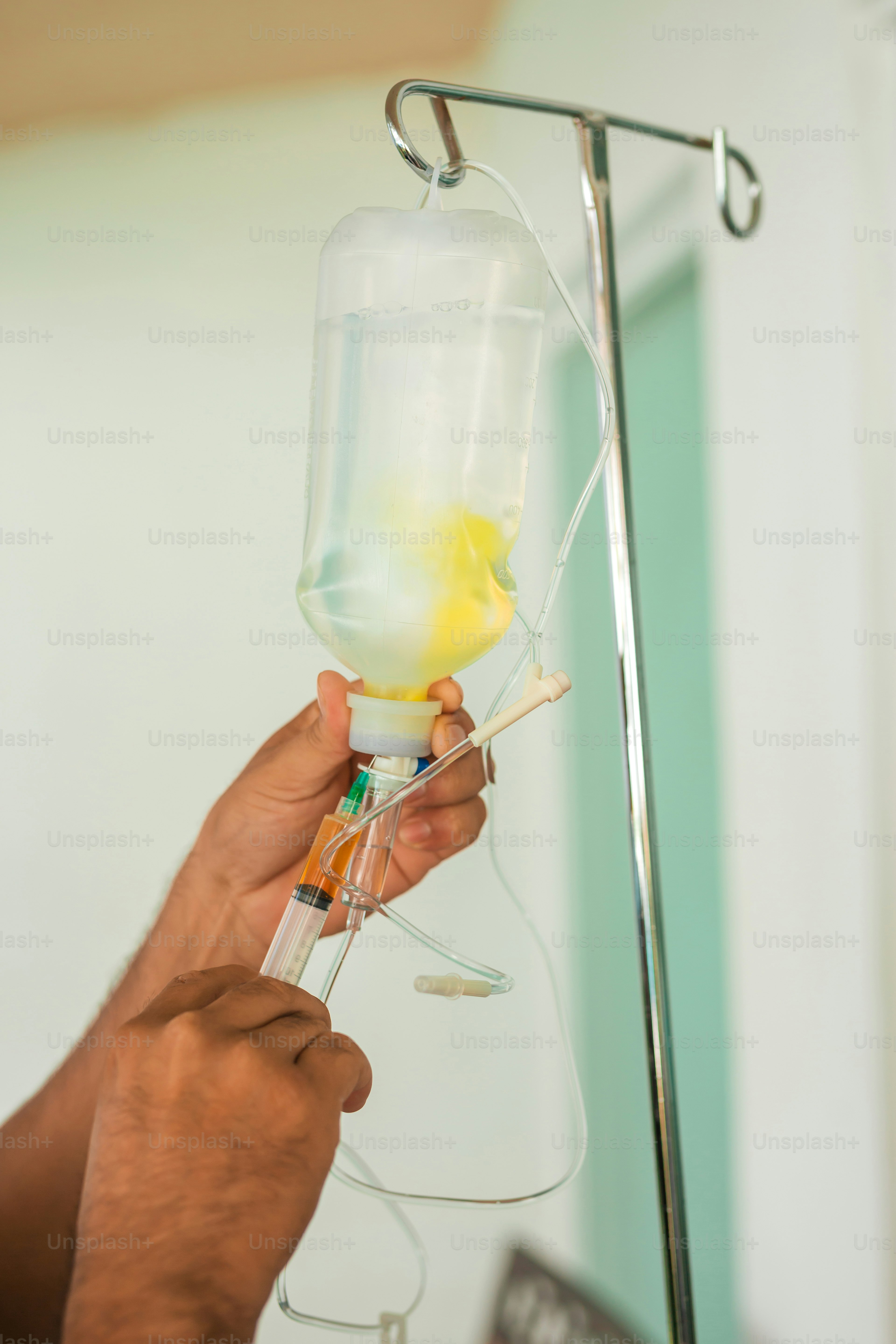 a person holding a wine glass with a yellow liquid in it