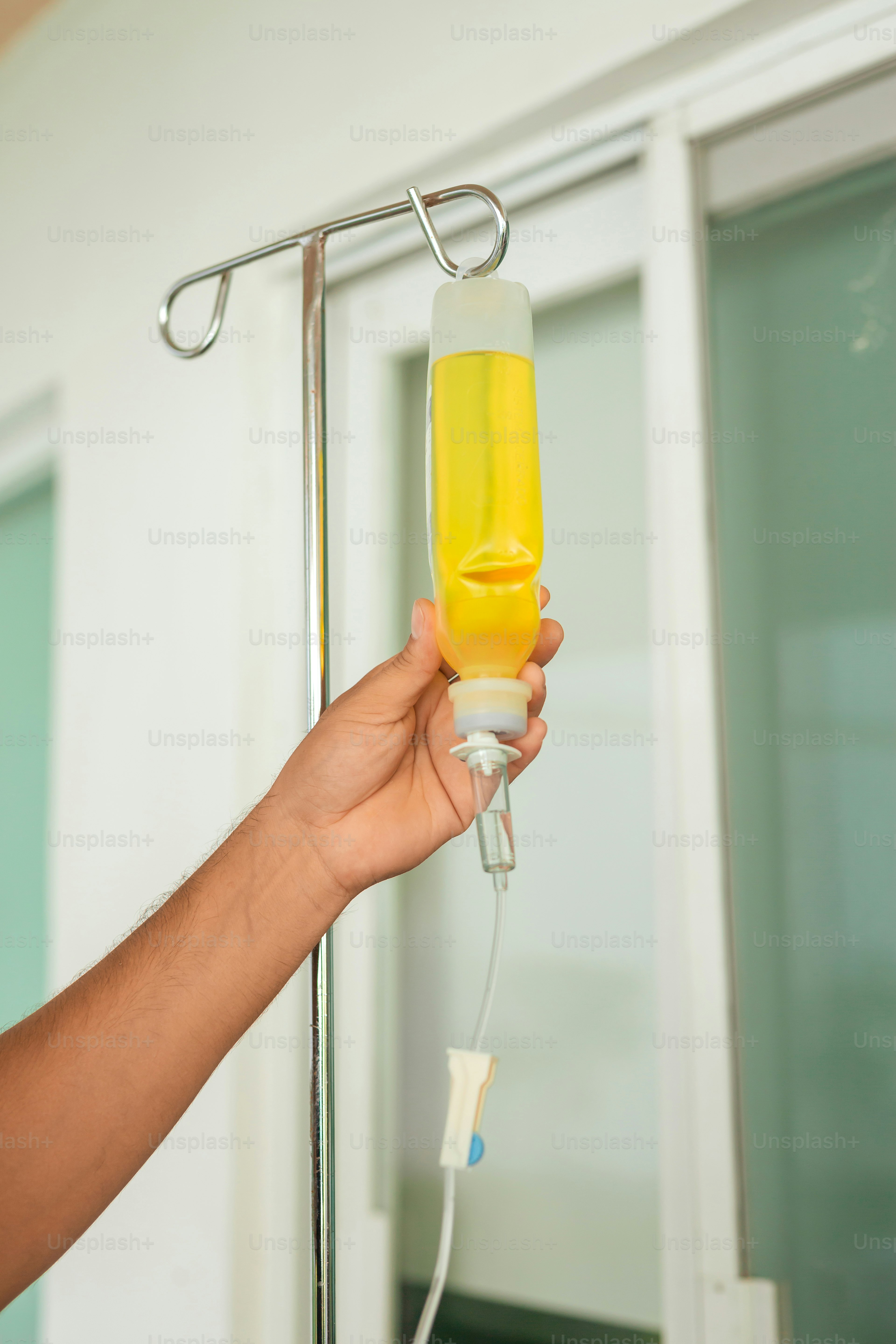 a person is holding a bottle of liquid