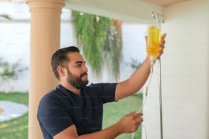 a man holding a glass of orange juice