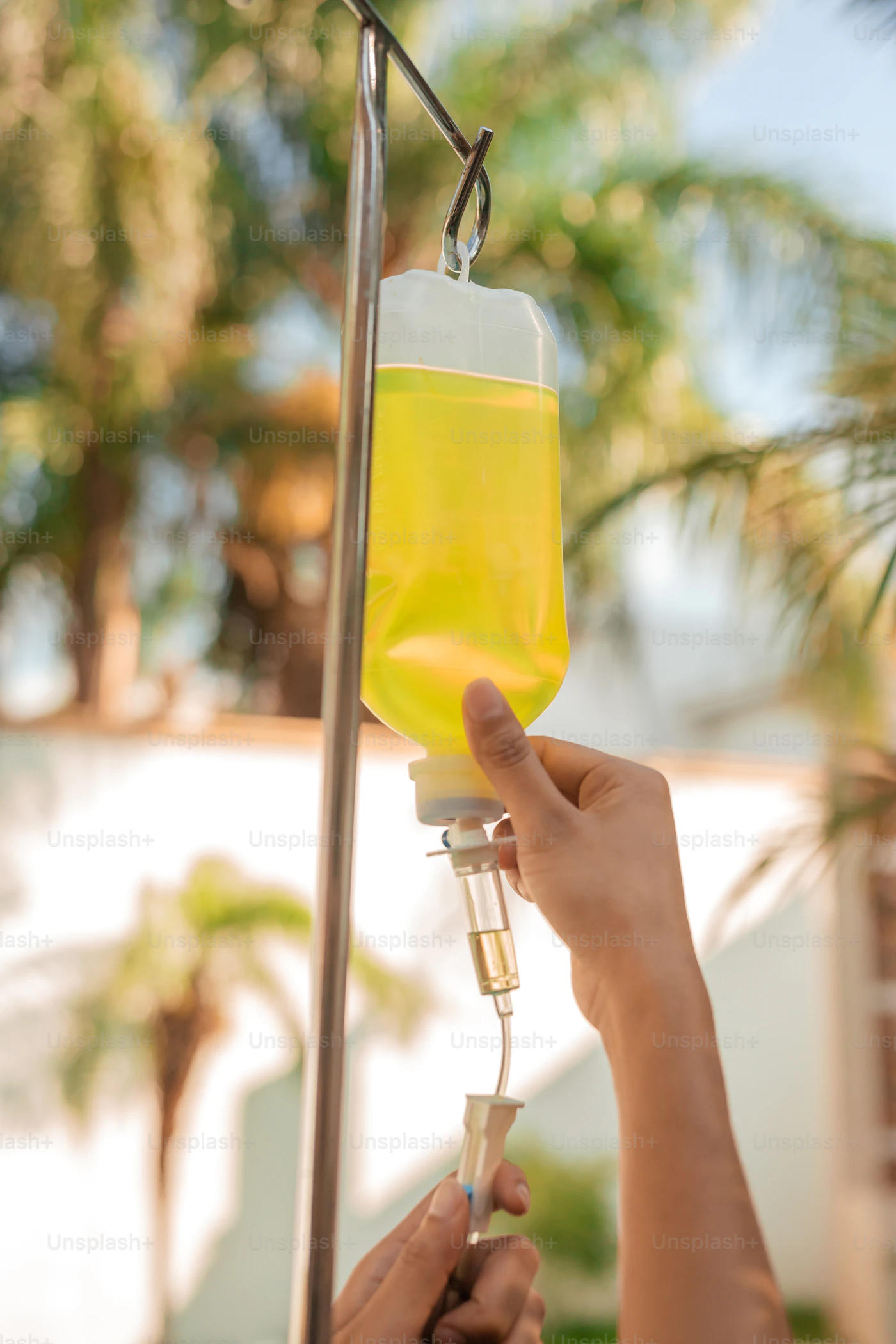 Golden vitamin IV drip in natural light