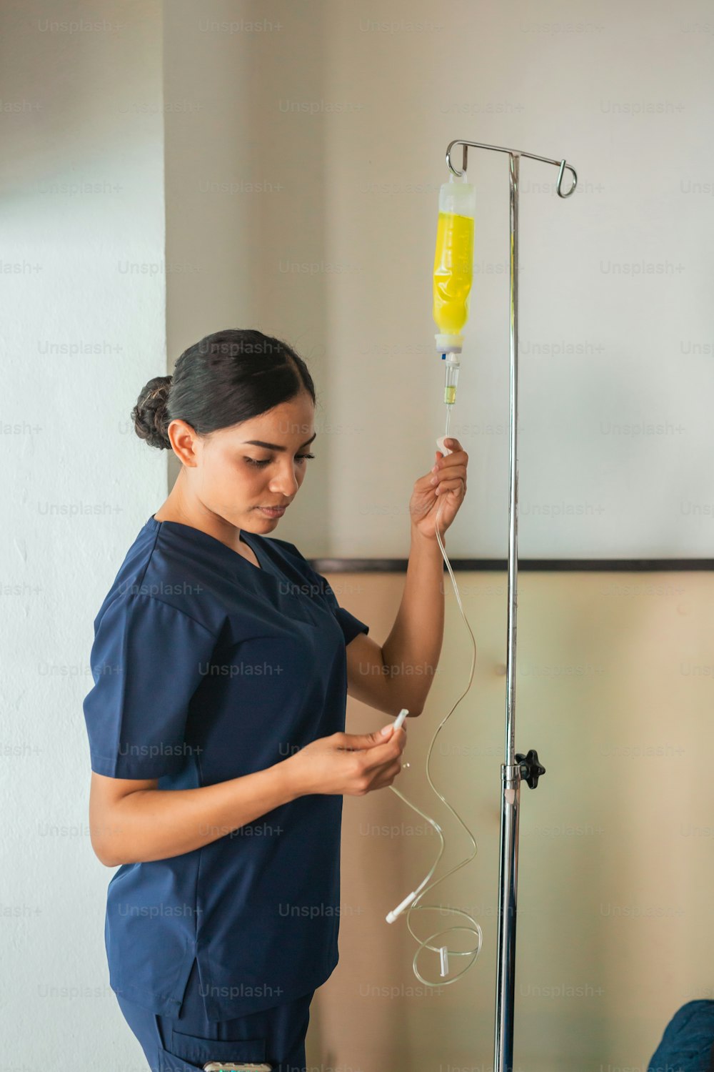 a woman in scrubs is holding a medical device