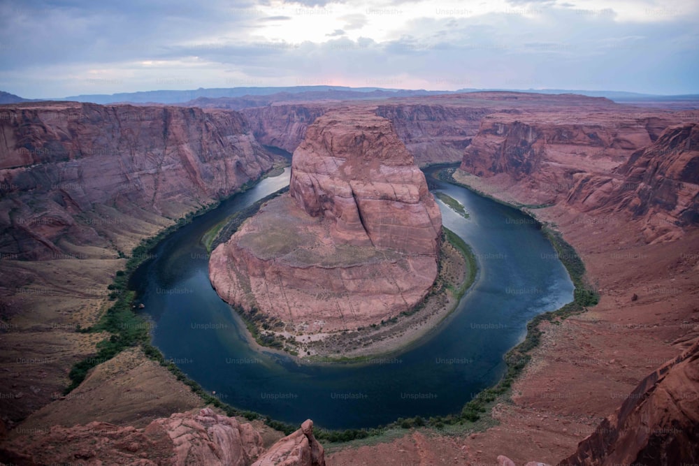 a river flowing through a canyon surrounded by mountains