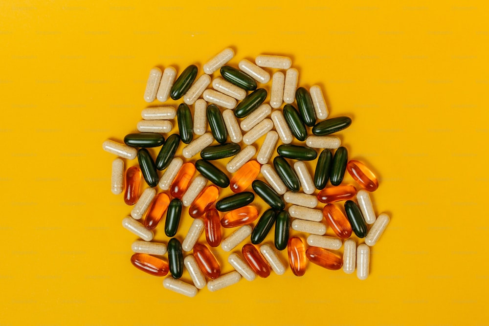 a pile of pills sitting on top of a yellow table